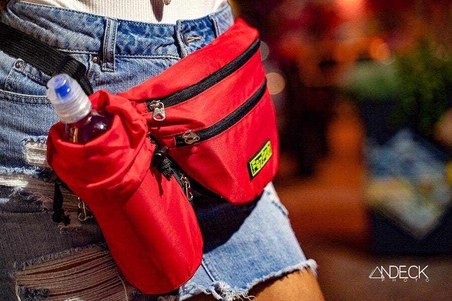 Red FezPak customizable fanny pack with attachable bottle holder worn with denim shorts
