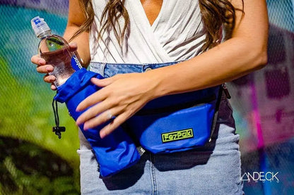 FezPak fanny pack with bottle holder attachment, worn as a crossbody, in vibrant blue color.