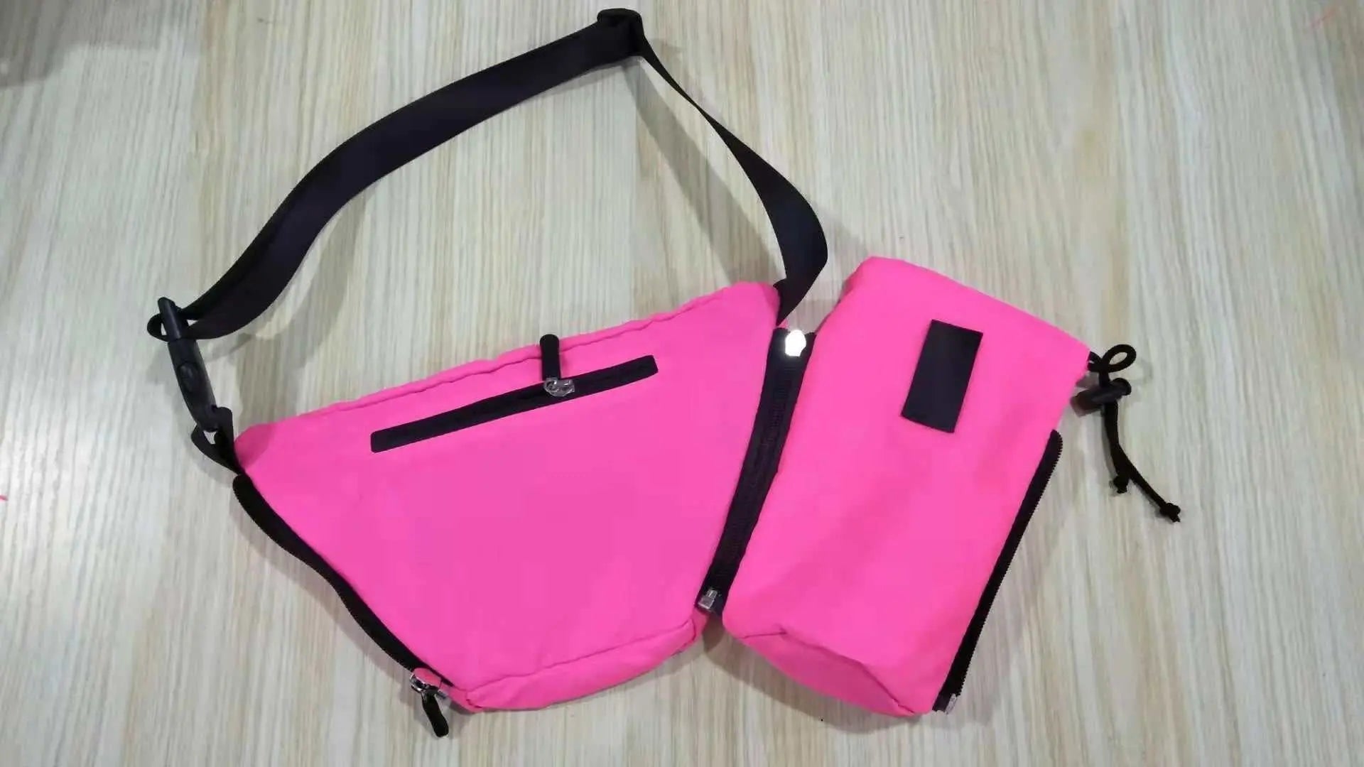 FezPak customizable fanny pack with detachable bottle holder, pink design on wooden surface.